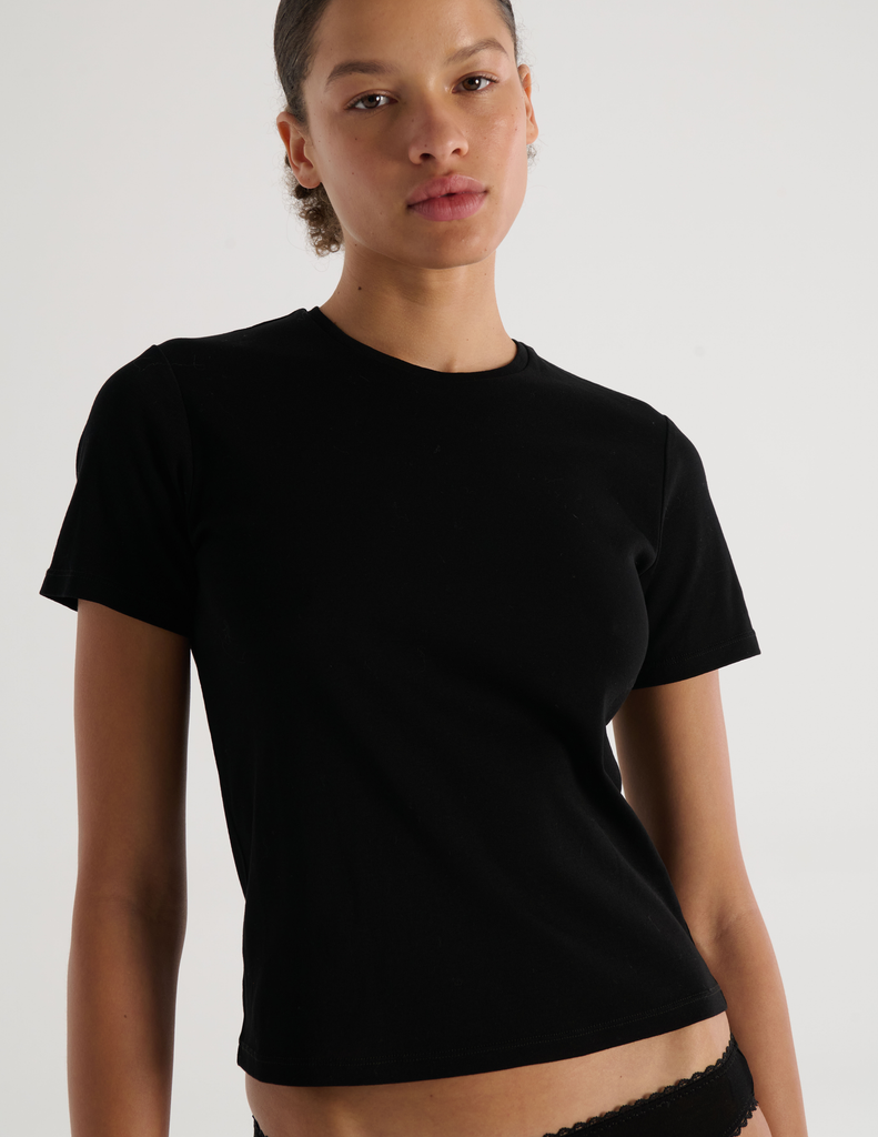 A model in the araks organic cotton tavi short sleeve in black