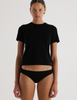 A model in the araks organic cotton tavi short sleeve in black