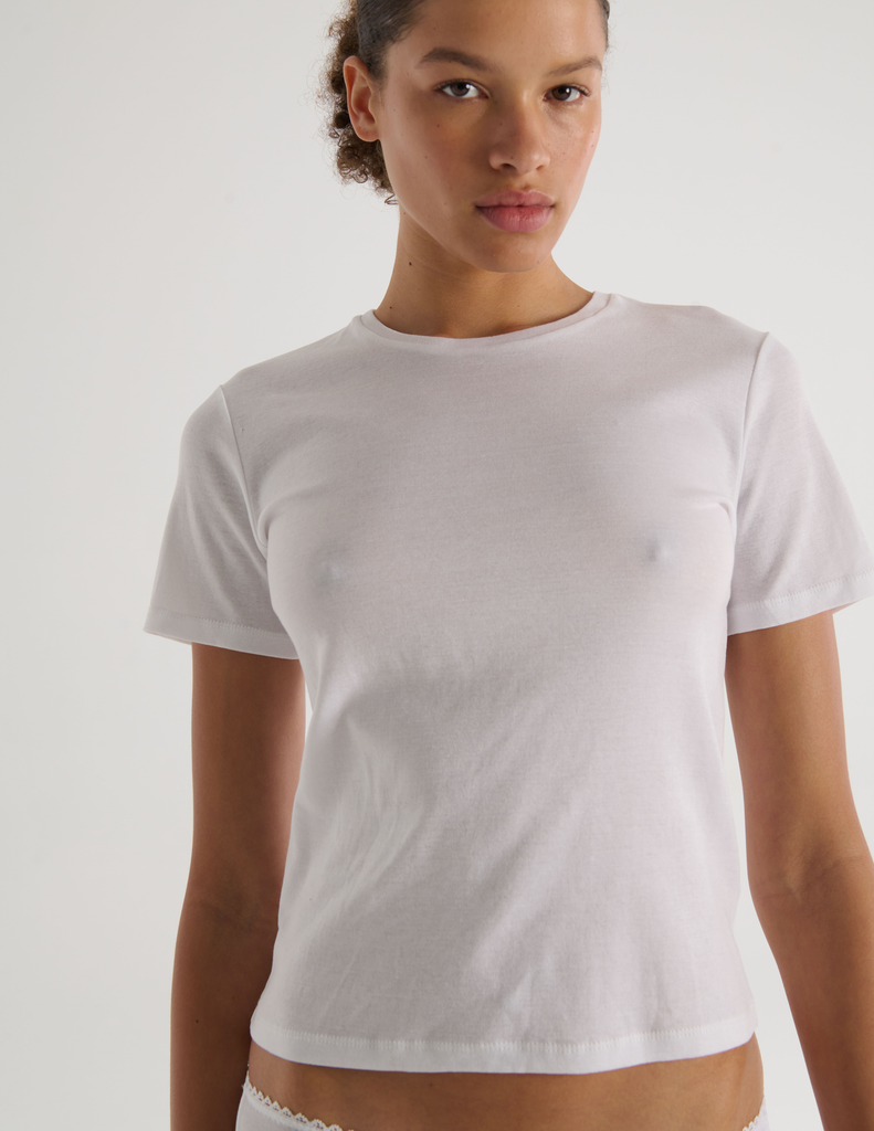 A model in the organic cotton araks tavi short sleeve and isabella panty in white