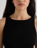 A model in the araks organic cotton uki tank and presley short in black
