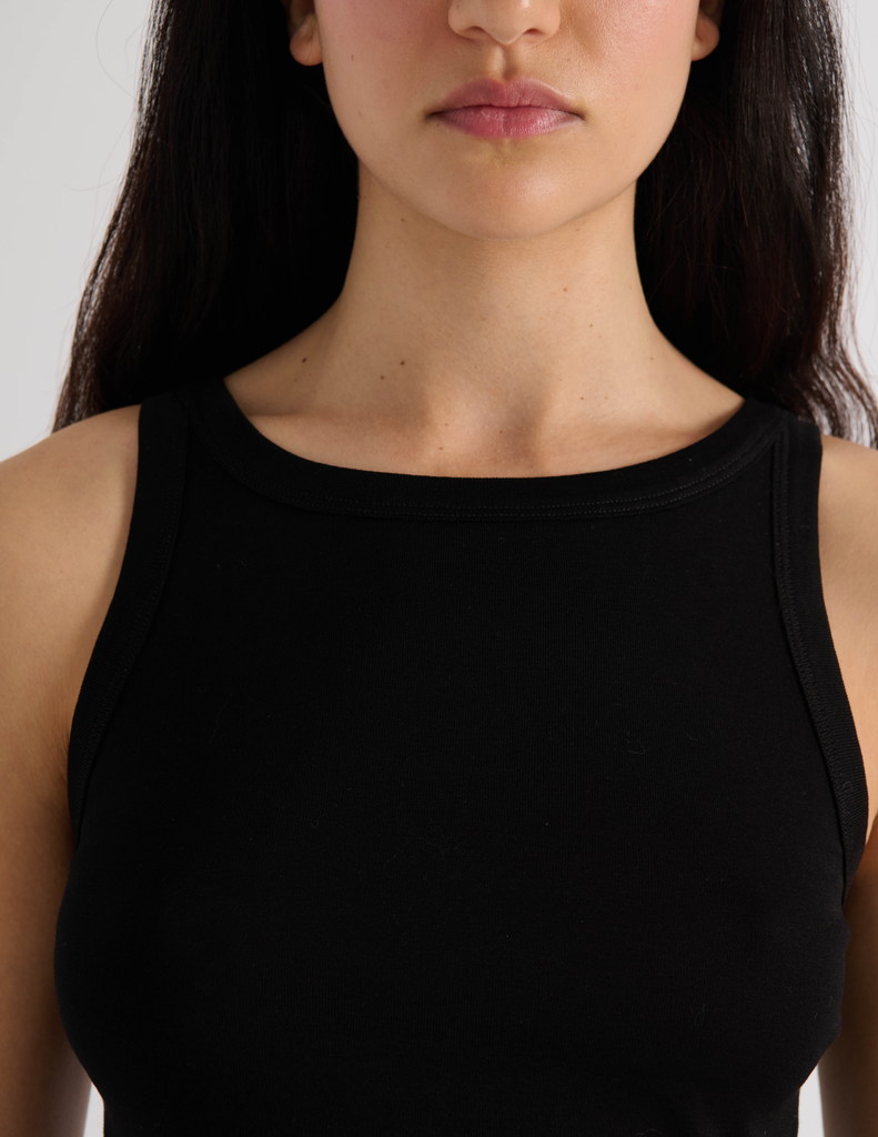 A model in the araks organic cotton uki tank and presley short in black