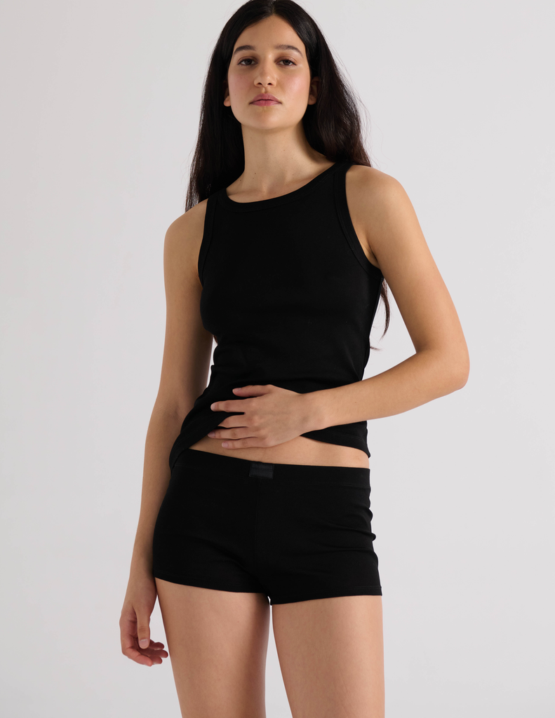 A model in the araks organic cotton uki tank and presley short in black