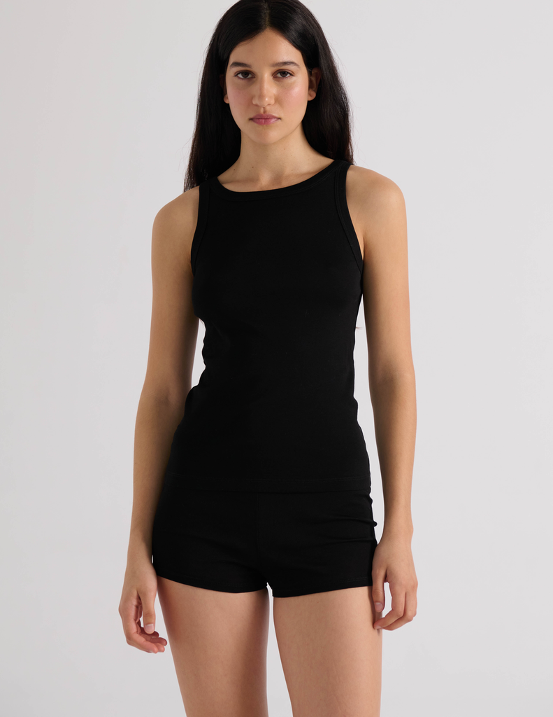 A model in the araks organic cotton uki tank and presley short in black