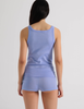 A model in the araks organic cotton uki tank and presley short in rococo blue