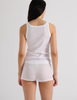A model in the Araks organic cotton uki tank and presley short in white