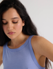 A model in the araks organic cotton uki tank and presley short in rococo blue