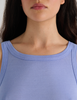 A model in the araks organic cotton uki tank and presley short in rococo blue