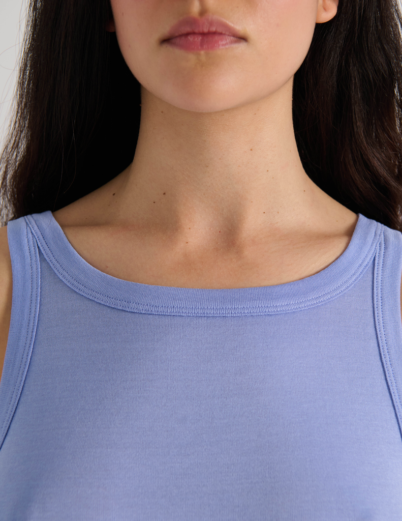 A model in the araks organic cotton uki tank and presley short in rococo blue