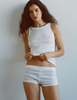 A model in the Araks organic cotton uki tank and presley short in white