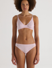 A model in the araks recycled cotton briar bralette in confection pink