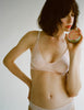 A model in the Araks recycled cotton briar bralette and josie panty in bare