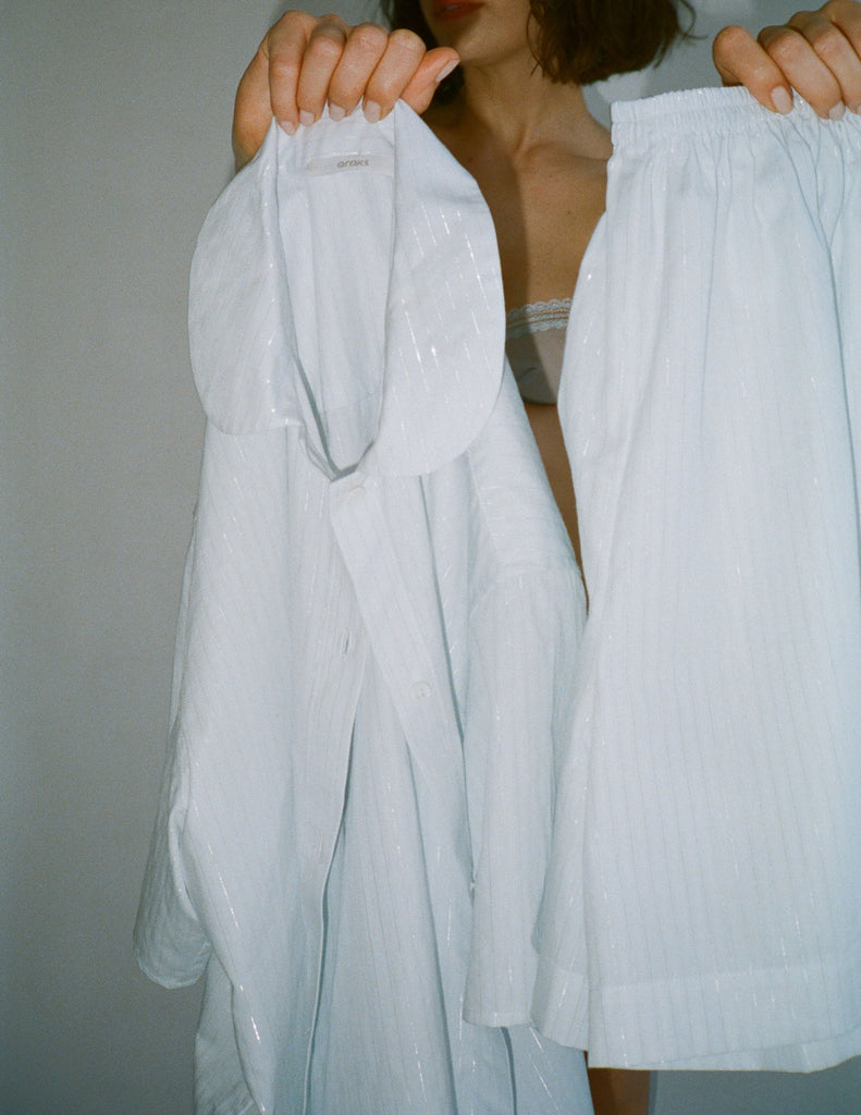 A model holding the 100% organic cotton araks samira pajama top and rose boxer