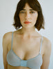 a model in the araks silk and cotton uma bralette in mist blue grey