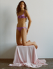 A model in the araks silk gita underwire bra and gwyneth panty in viola purple