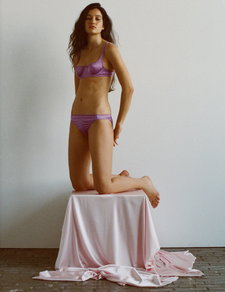 A model in the araks silk gita underwire bra and gwyneth panty in viola purple