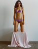 A model in the araks silk gita underwire bra and gwyneth panty in viola purple