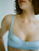 a model in the araks silk penelope bralette in glace blue