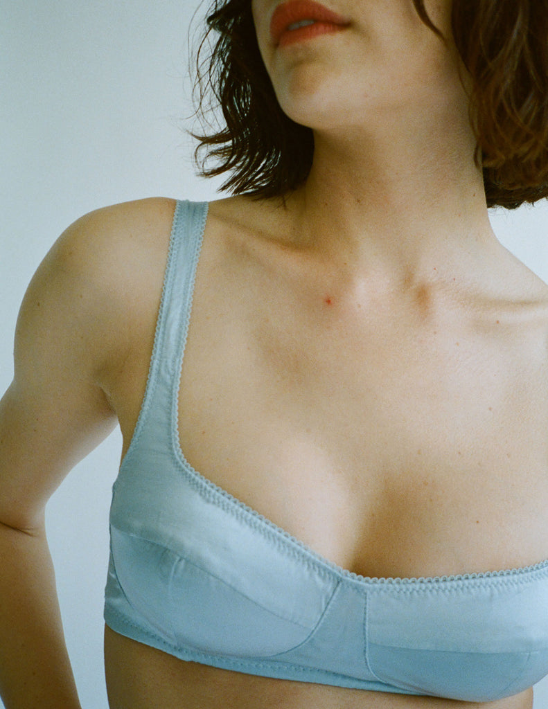 a model in the araks silk penelope bralette in glace blue