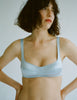 a model in the araks silk penelope bralette in glace blue