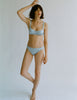 a model in the araks silk penelope bralette in glace blue