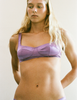 A model in the araks silk penelope bralette and gwyneth panty in viola purple