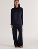 A model in the Araks sea silk suki pajama top and ally pajama pant