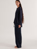 A model in the Araks silk suki pajama top and ally pajama pant in sea silk