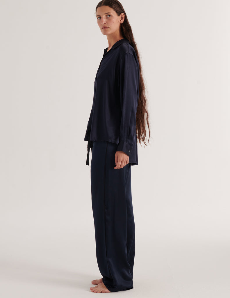 A model in the Araks silk suki pajama top and ally pajama pant in sea silk
