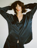 A model in the araks silk suki pajama top in sea navy