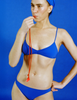 A model in the araks tessa bikini top and piper bikini bottom in azure