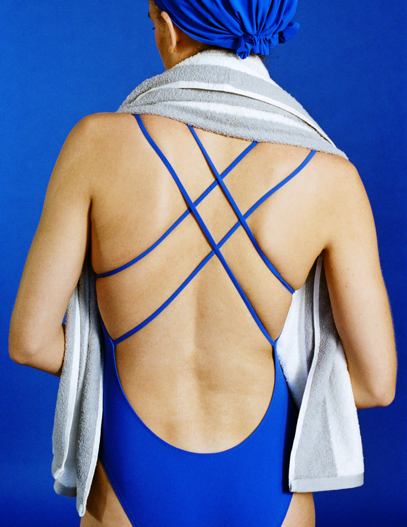 A model in the araks blue tallulah one piece in azure blue