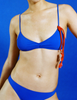 A model in the araks tessa bikini top and piper bikini bottom in azure