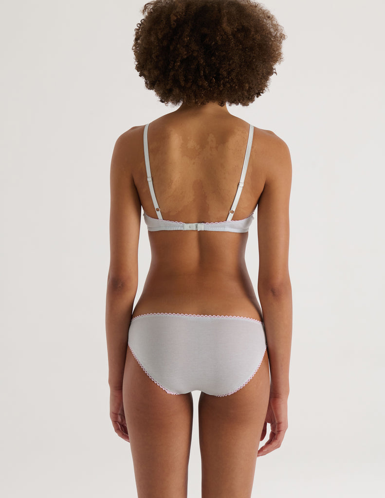 A model in the 100% organic cotton antonia bralette and isabella panty in fondant blue