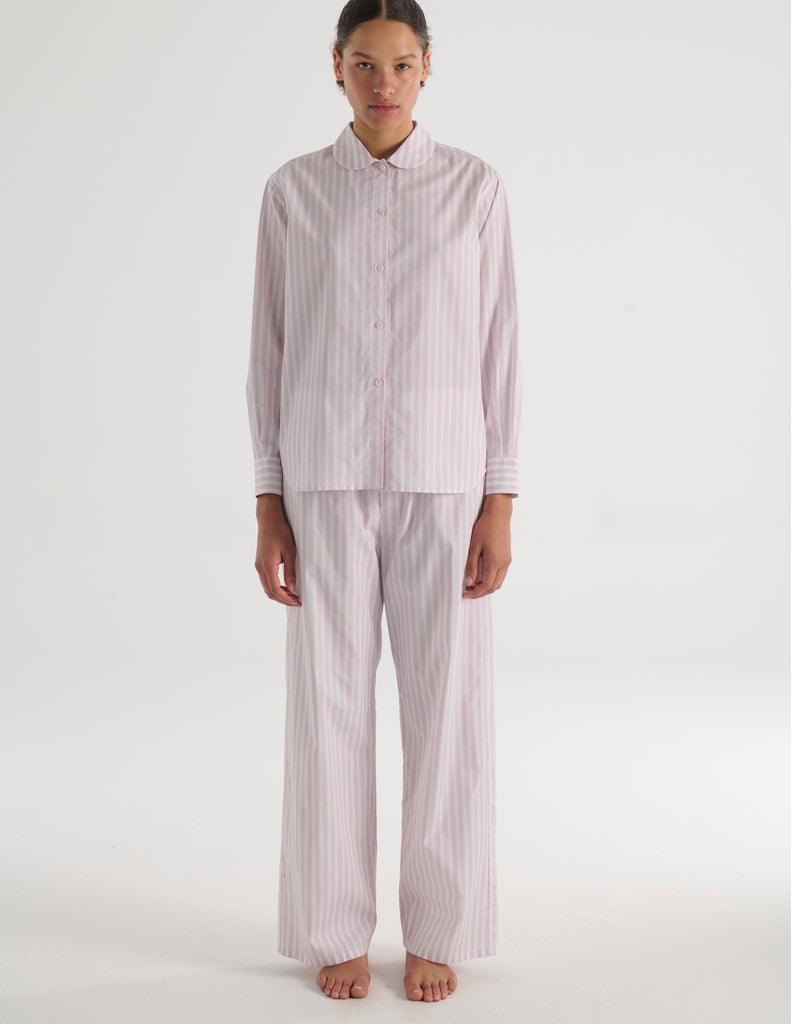 A model in the Araks suki pajama top in tart stripe and teagen pajama pant