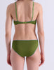A model shown from the back wearing Araks Antonia bralette and Isabella panty in Moss set against a plain light gray background.
