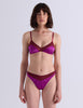 A model wearing Araks Beatrice bralette with Maya thong in Raspberry.