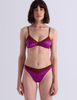A model wearing Araks Beatrice bralette with Maya thong in Raspberry.