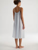 Woman wearing a light gray Raffaela slip dress on a white background