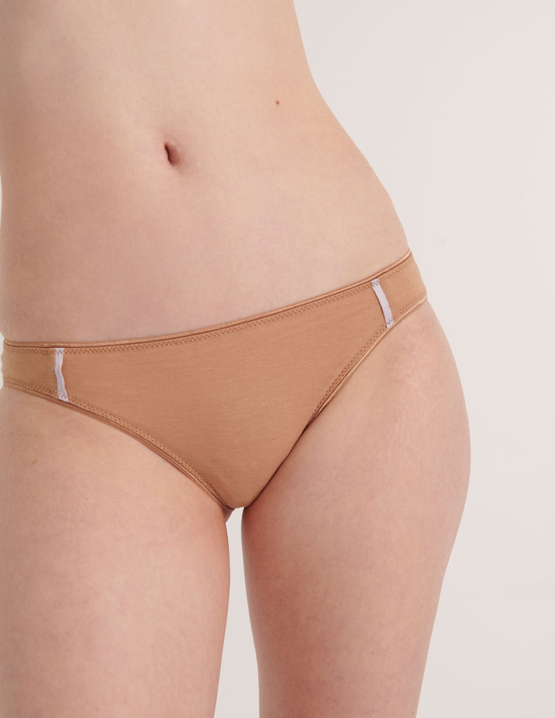 A model in the araks cotton and silk harriet panty in brulee brown