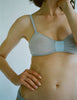 a model in the araks silk and cotton uma bralette in mist grey blue