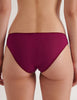 A model in the araks cotton crepe harriet panty in cranberry red