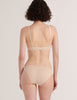A model from the back in the cotton and silk willow bralette and harriet panty in lavender and cream