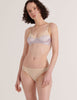 A model in the araks cotton and silk willow bralette and harriet panty in lavender and cream
