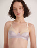 A model in the Araks cotton and silk willow bralette in tulle cream and purple