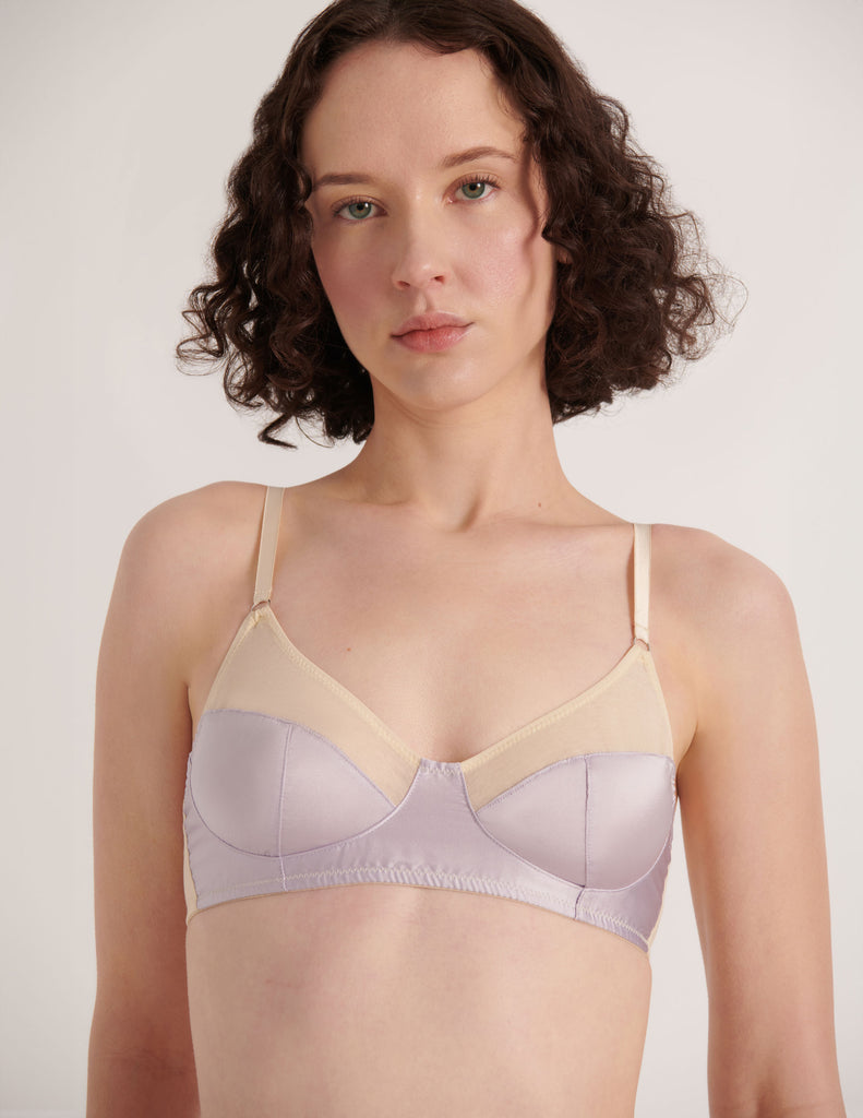 A model in the Araks cotton and silk willow bralette in tulle cream and purple