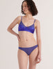 A model in the araks silk and cotton willow bralette and harriet panty in storm blue
