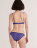 A model from the back in the araks silk and cotton willow bra and harriet panty in storm blue