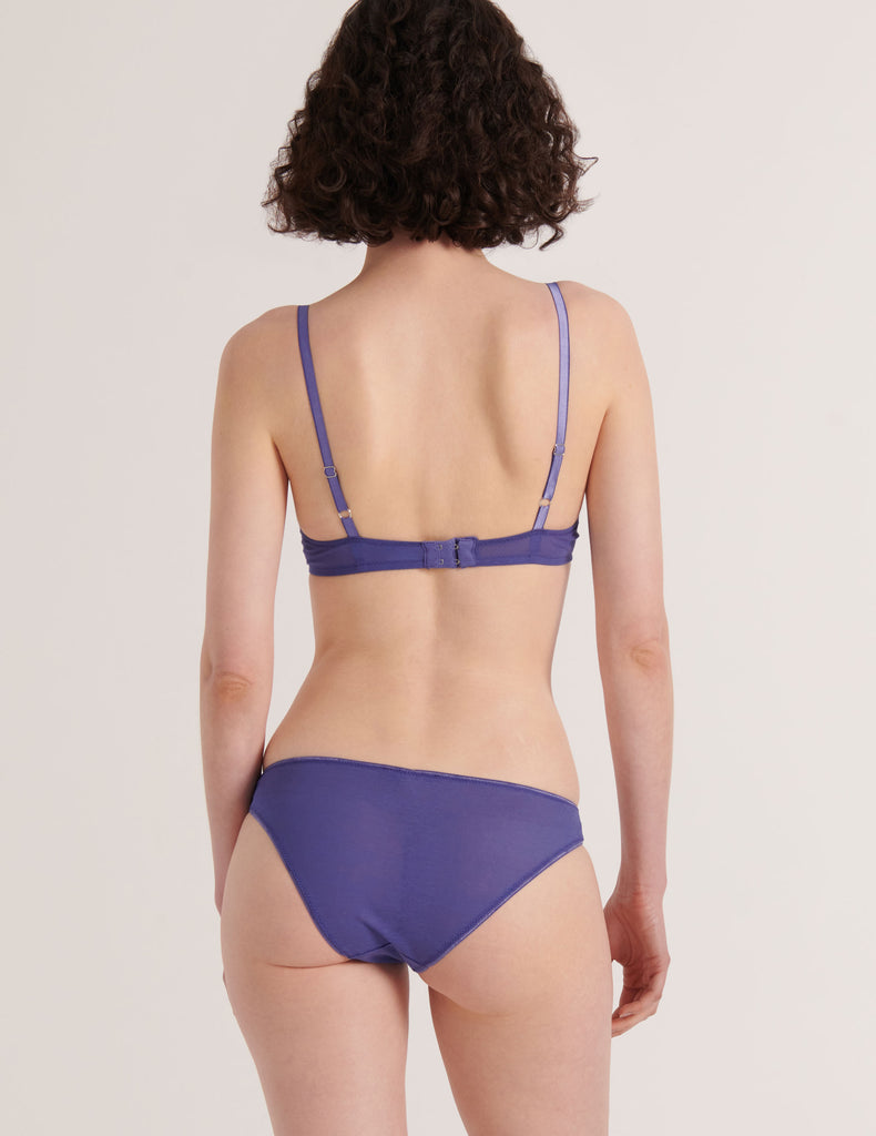 A model from the back in the araks silk and cotton willow bra and harriet panty in storm blue