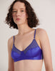 A model in the araks cotton and silk willow bralette in storm blue