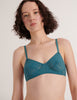 A model in the araks french stretch lace tamara bralette in heron blue